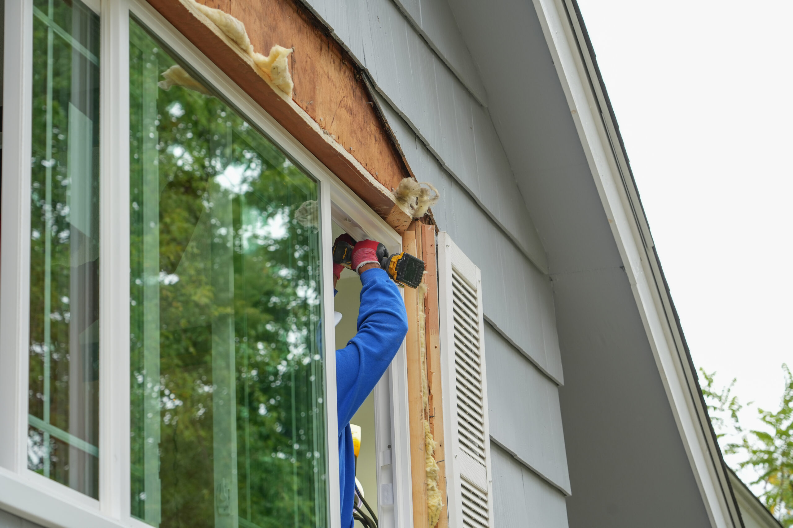 contractor working on replacing the window of the house